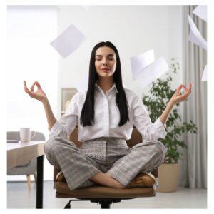 a woman meditating in a chair while papers fly