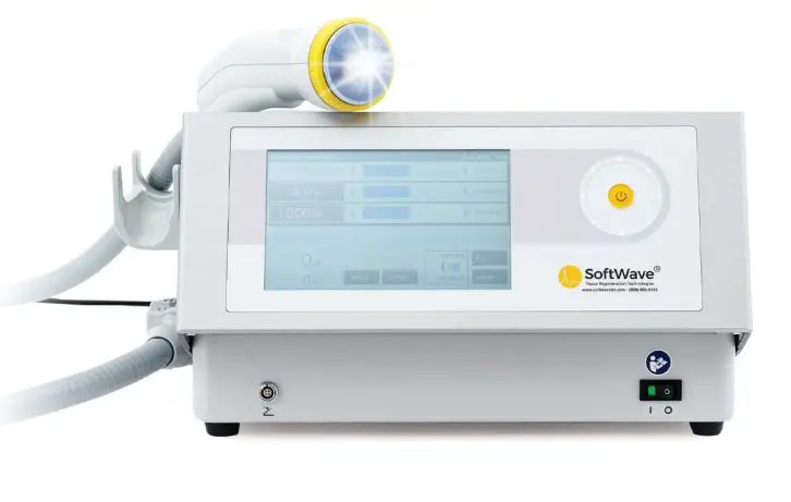 A white softwave device with a yellow light on top of it.