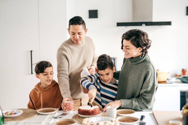 Two parent and two kids in domestic kitchen